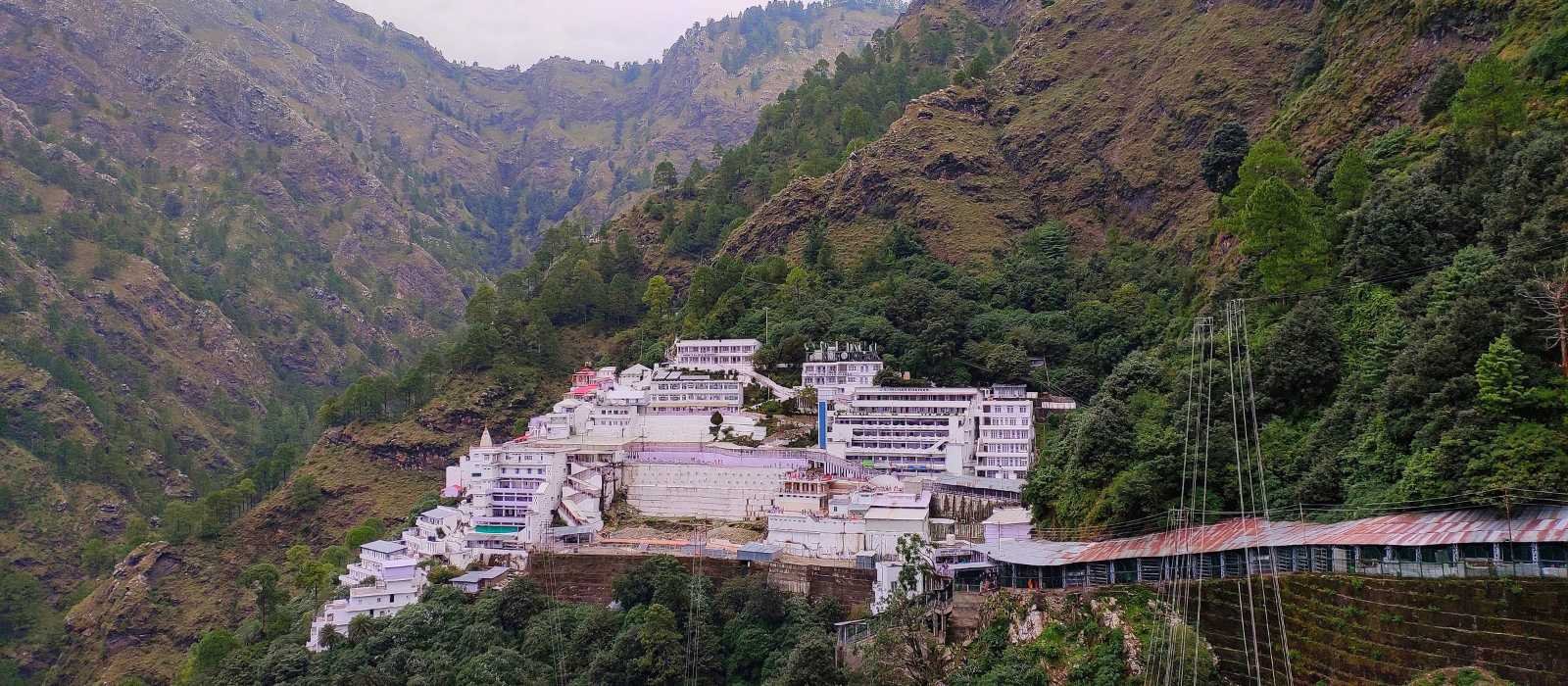 Vaishno Devi Temple on the mountain with a beautiful view, surrounded by scenic landscape.